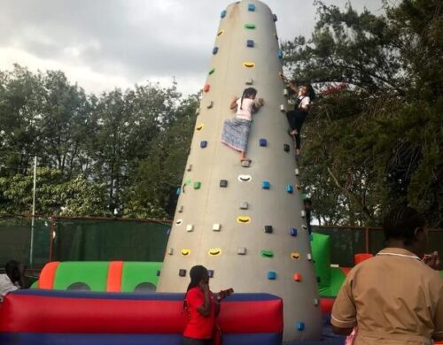 A kid climbing an inflatable wall