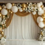 white and gold balloons with fairy lights and floral accents.