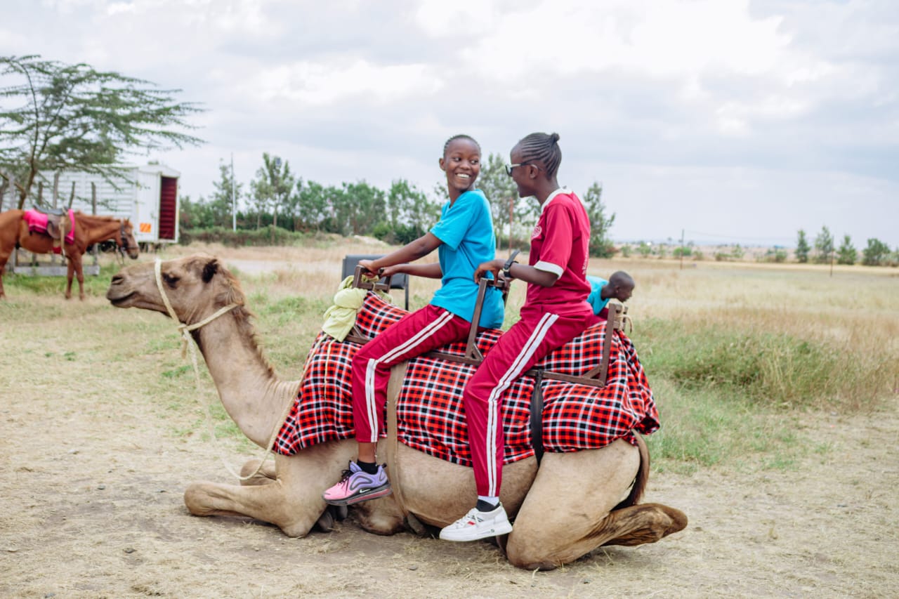 A camel carrying kids at a fun day in Nairobi